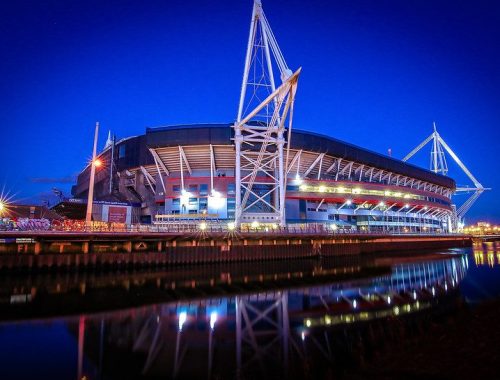 Principality Stadium Cardiff lit up at night viewws from Taff River side